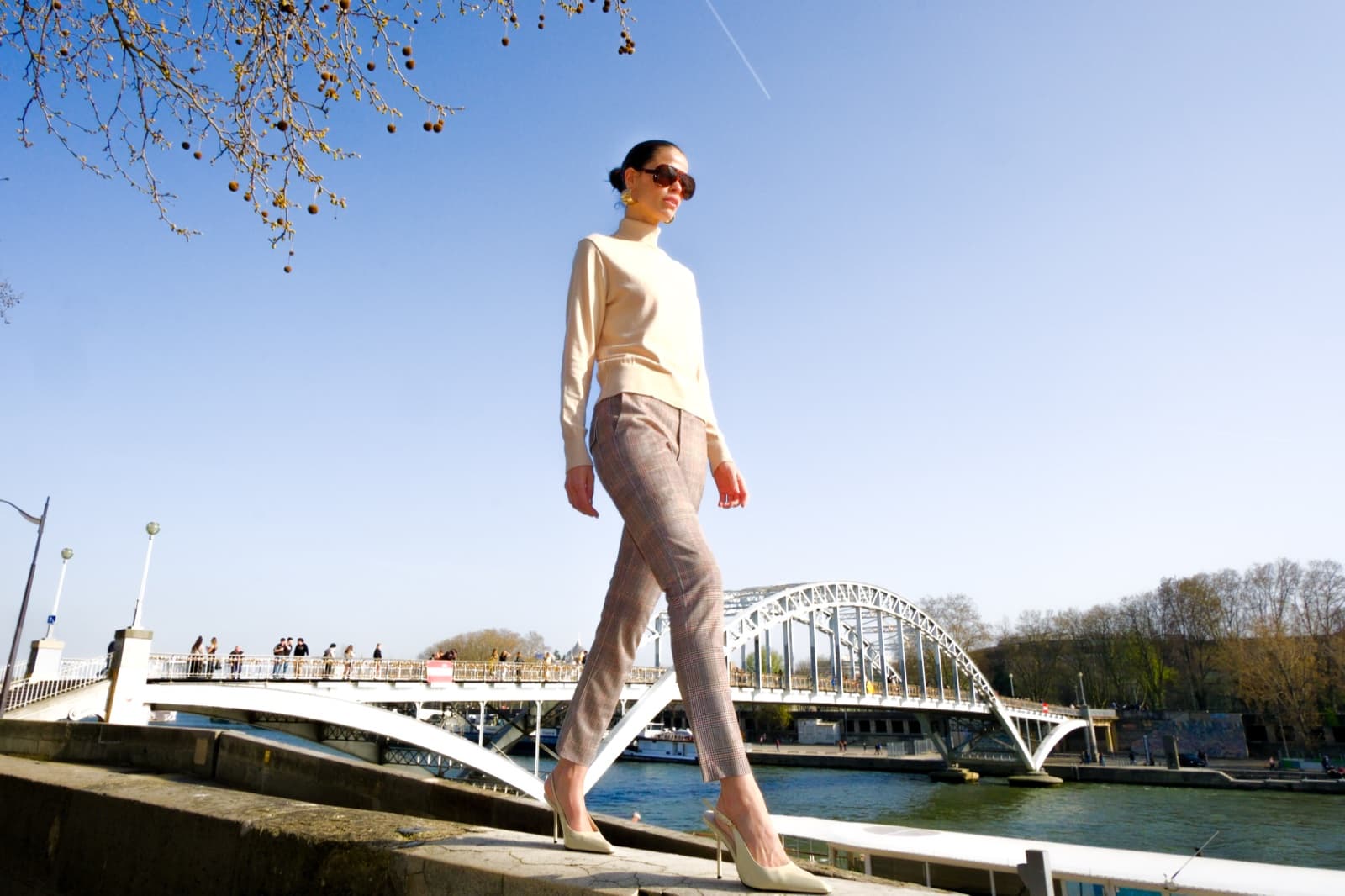 Editorial street style model walking across the Passerelle Debilly bridge over the Seine in Paris by SabShots