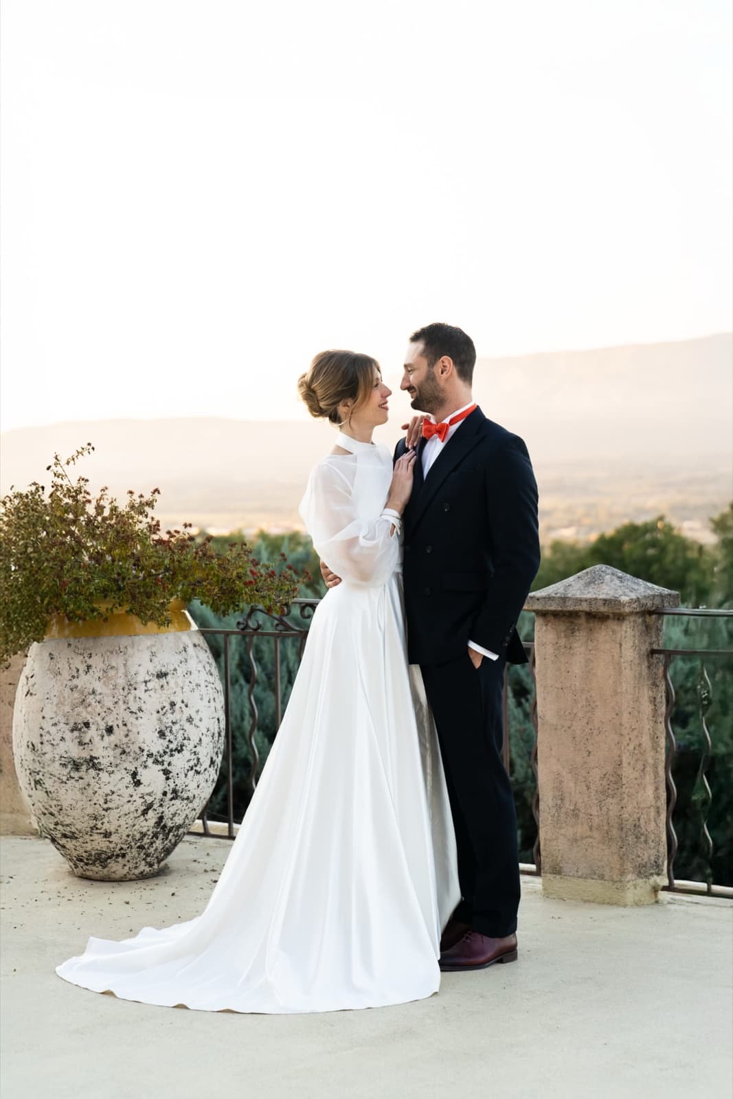 Elegant bride and groom embracing on a sunset terrace at a Paris wedding by SabShots