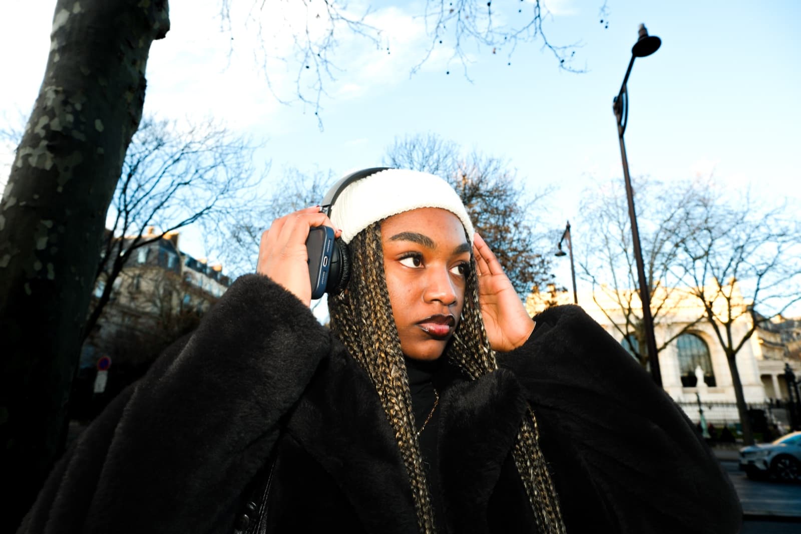 Woman in a fur coat on a crisp winter day in Paris, a cool instagrammable street style look by SabShots