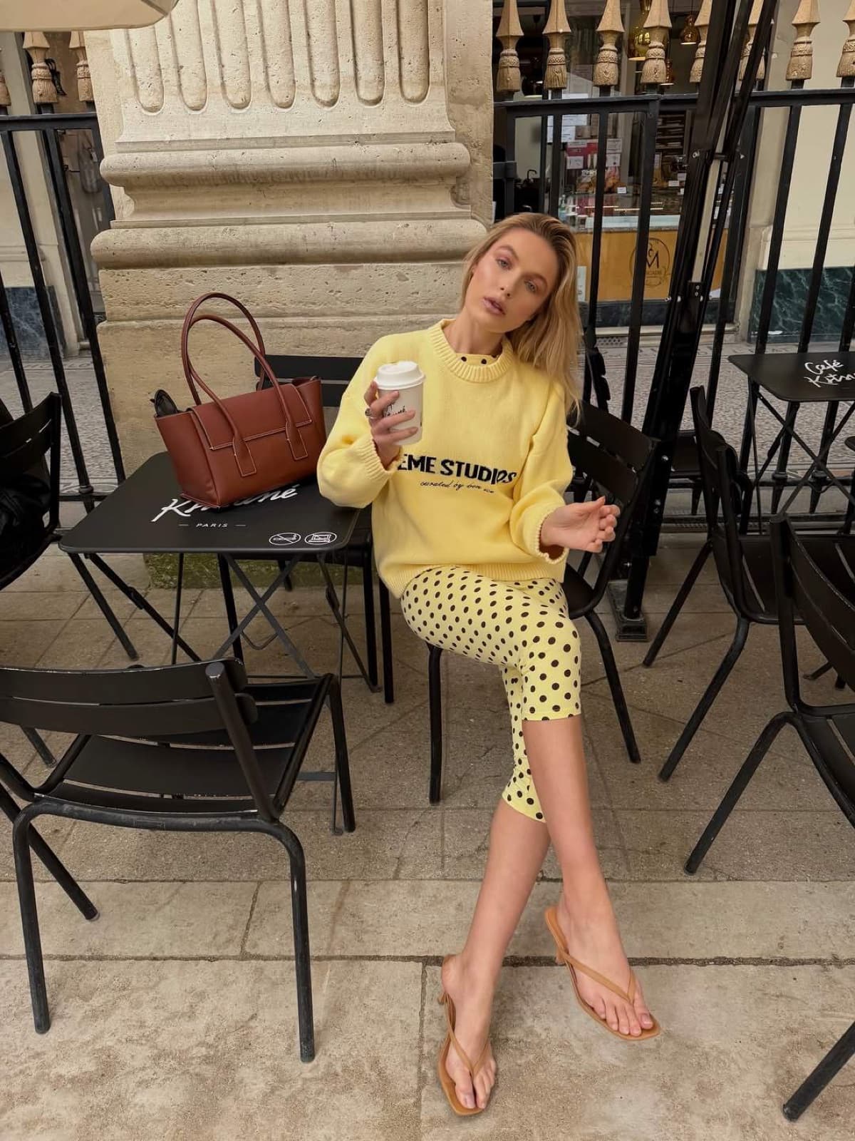 Woman in yellow at a classic Parisian cafe terrace, an aesthetic instagrammable Paris moment by SabShots