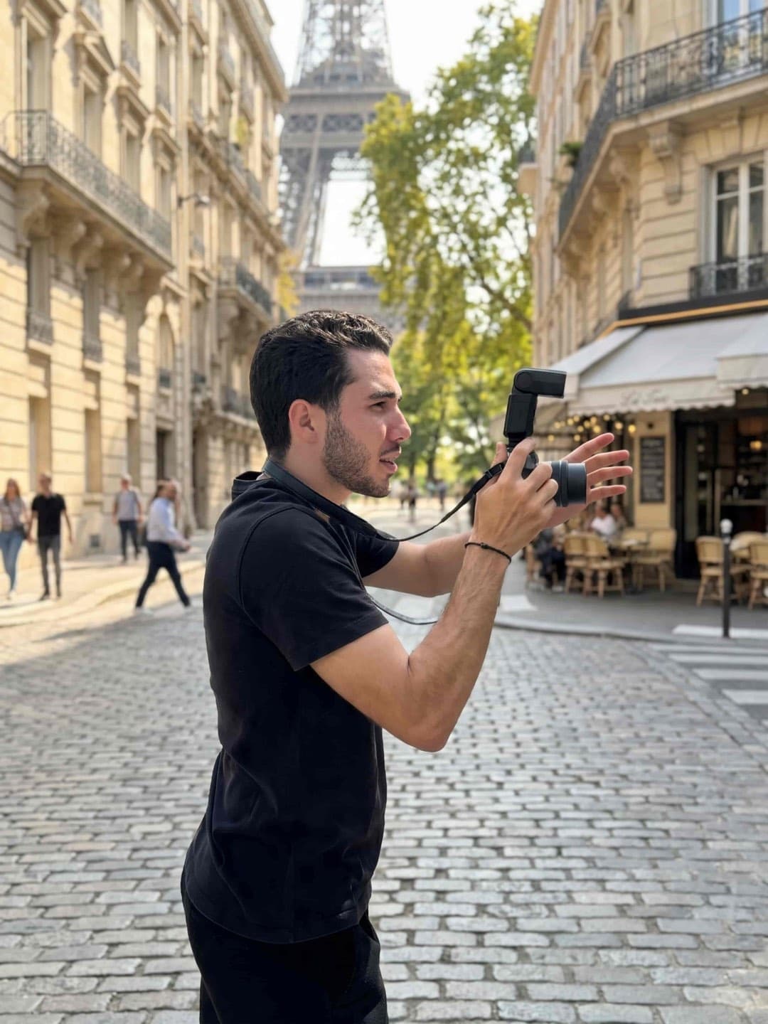 Yassir, SabShots photographer, shooting in a Paris street with the Eiffel Tower behind