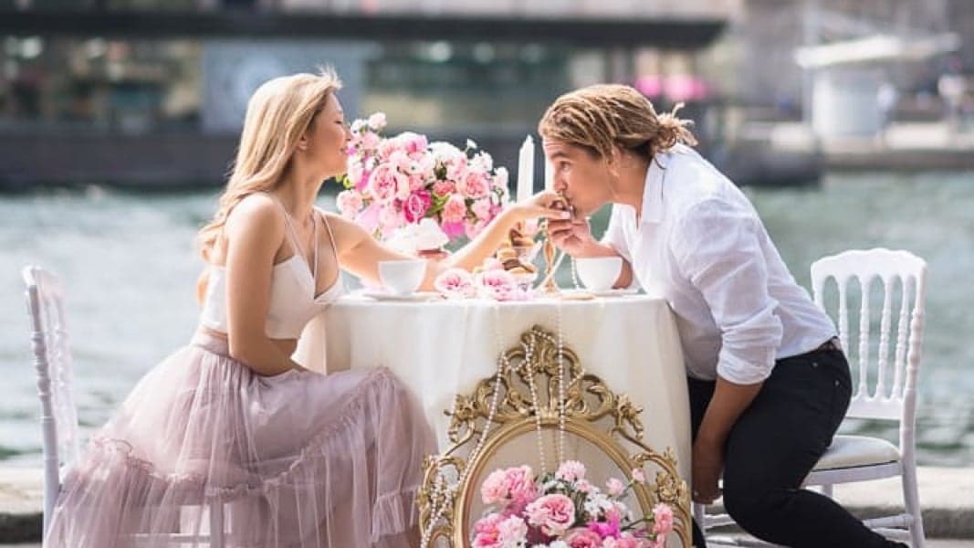 Couple at a candlelit proposal table with roses by the Seine facing the Eiffel Tower, ready to propose in Paris by SabShots