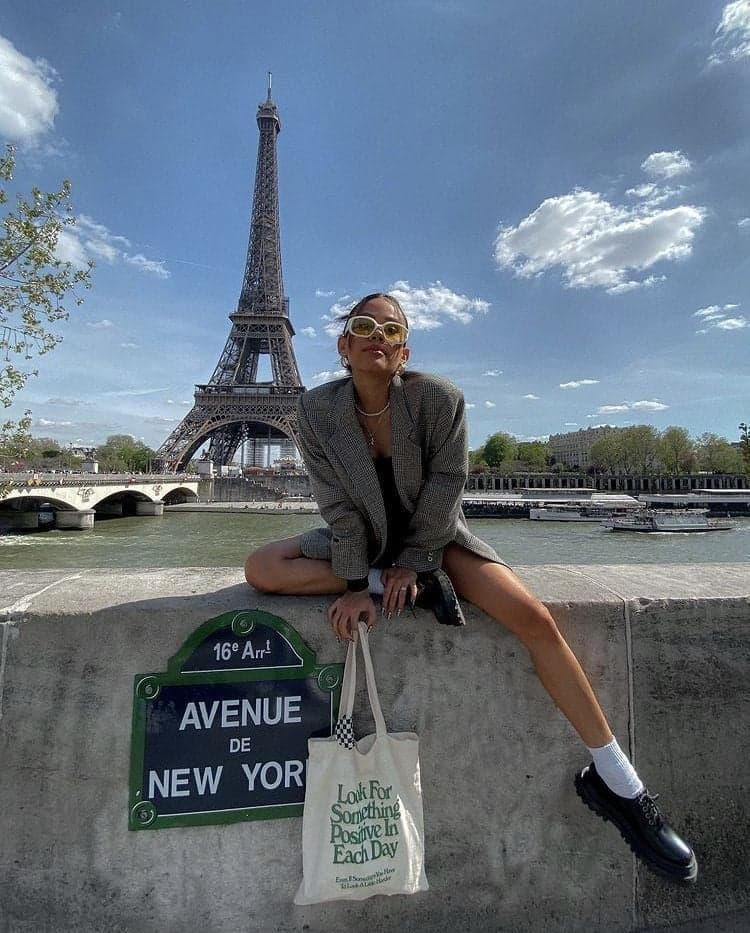 Woman in sunglasses on a Seine quay opposite the Eiffel Tower, an instagrammable Paris photo spot by SabShots