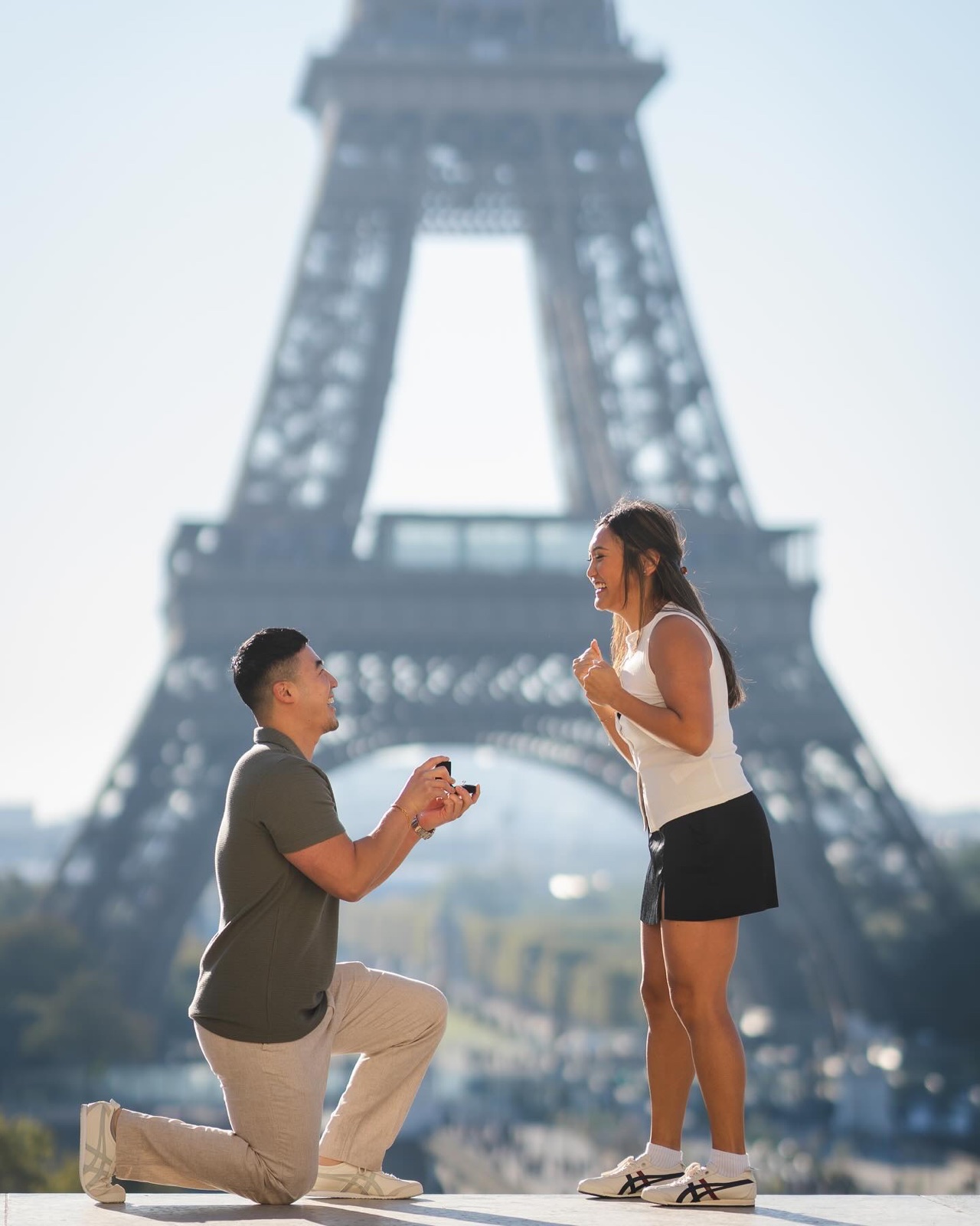 Man kneeling with a ring box as his girlfriend reacts at the Trocadero, a surprise proposal in Paris by SabShots